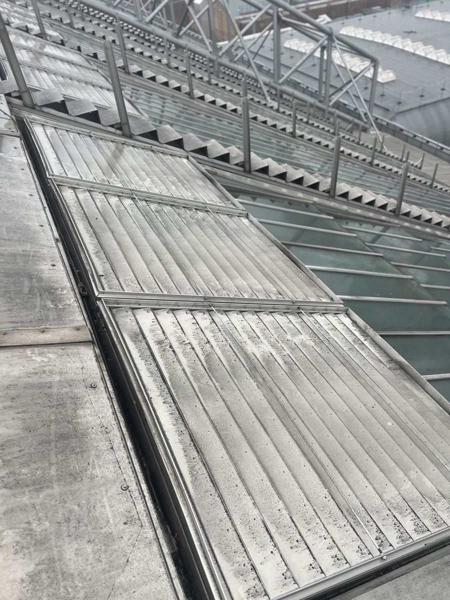 The same view along the Alexandra Palace roof with the vent closing again after the seized mechanism was freed