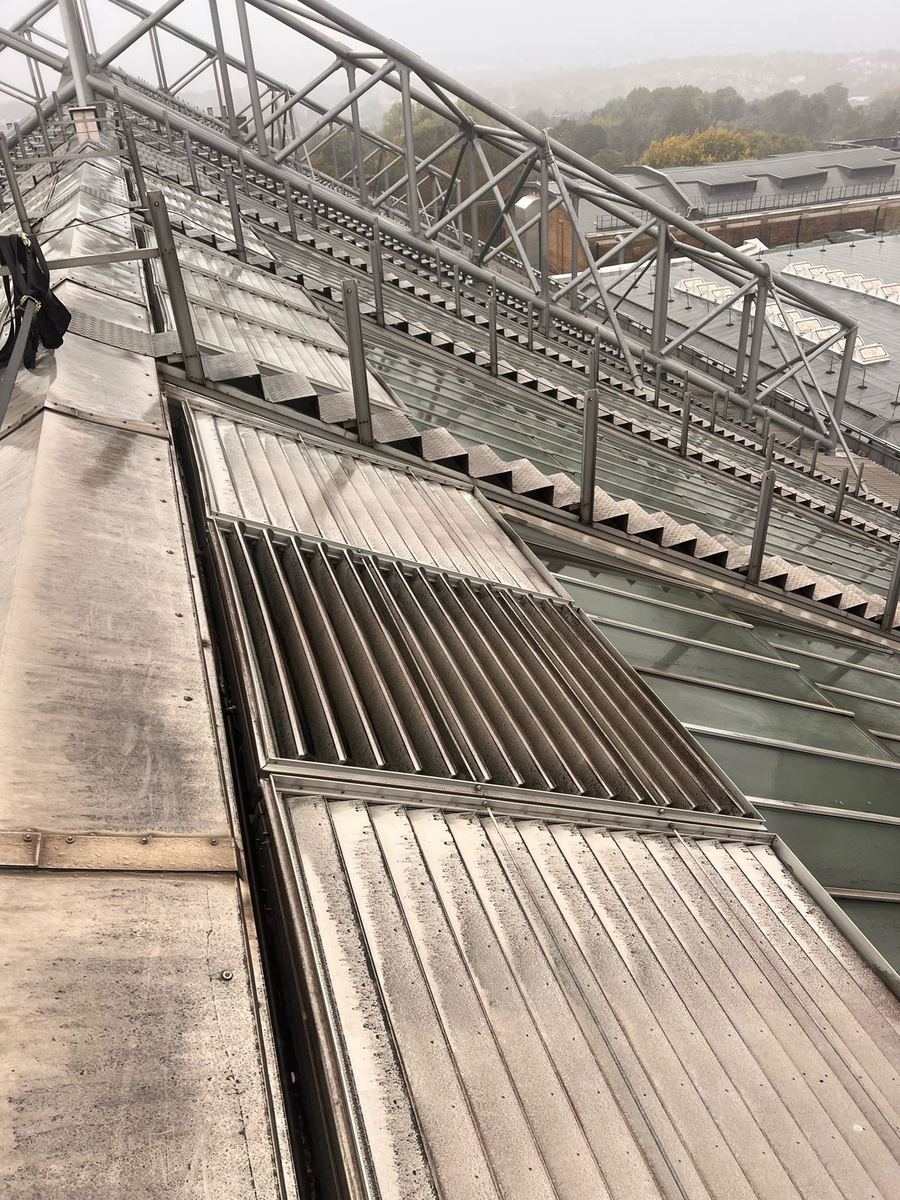 Wide view along the Alexandra Palace roof showing a louvred vent seized open, before the make safe