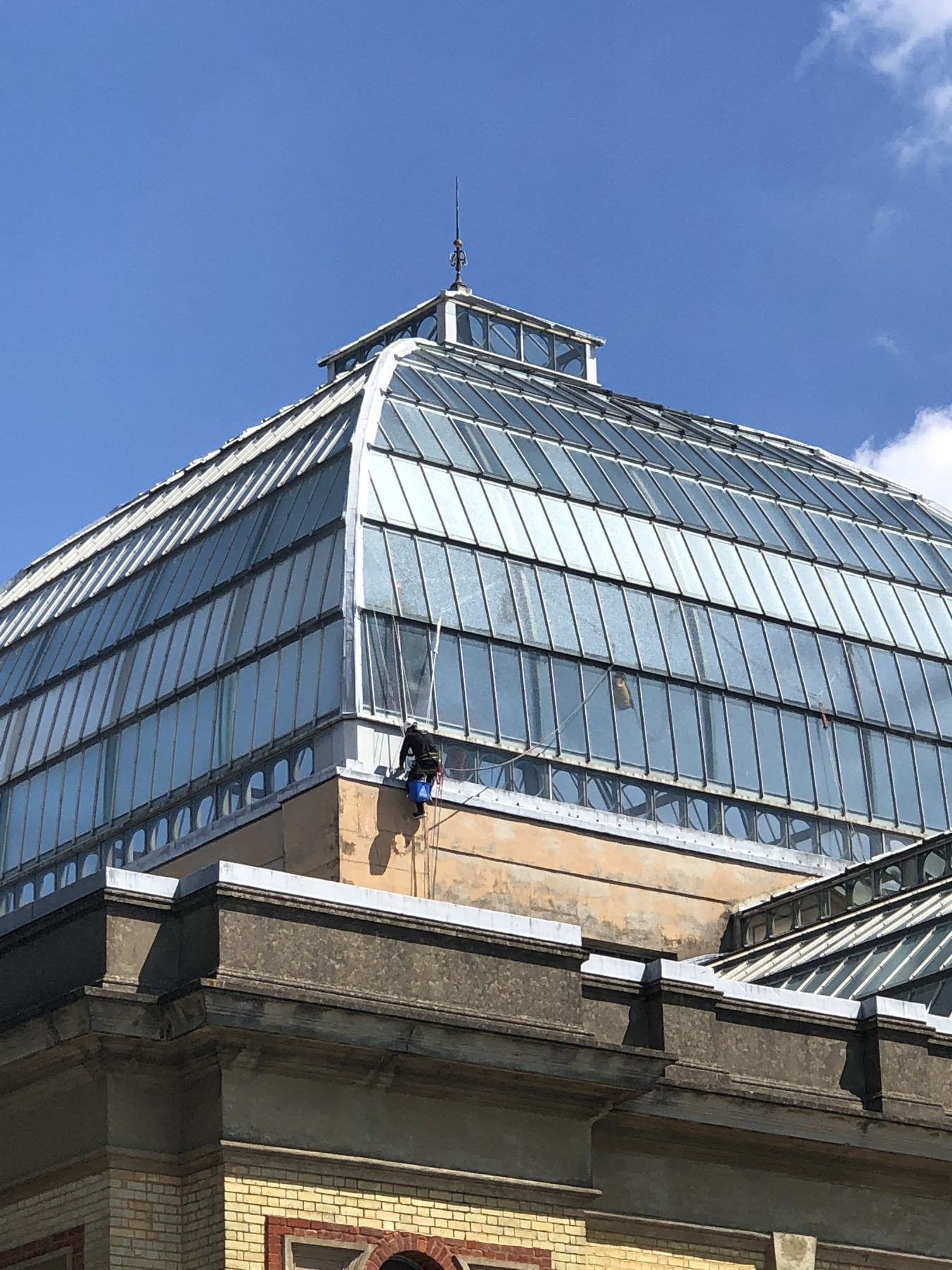 Rope-access technician on the Victorian glass dome at Alexandra Palace, Grade II listed venue