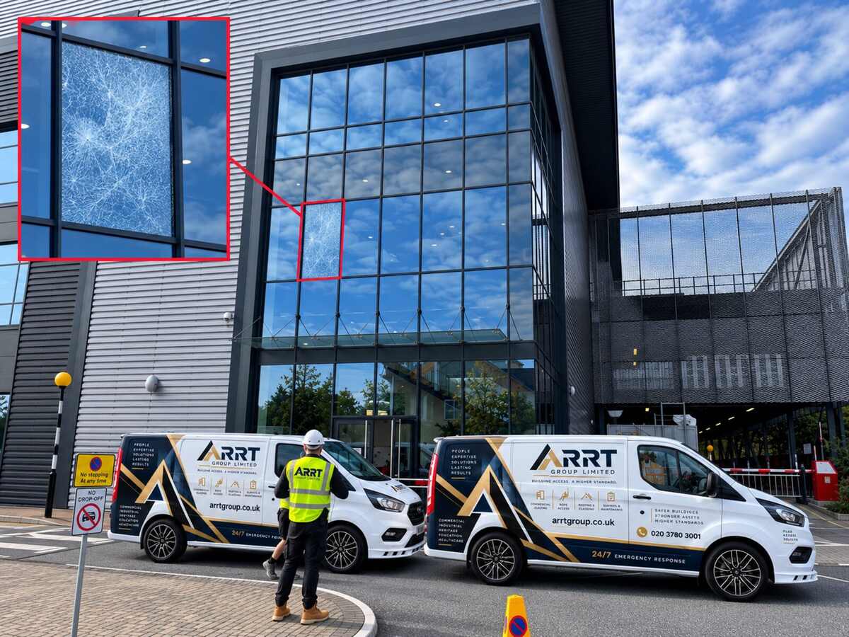 ARRT vans and technician at a commercial curtain-wall façade with shattered glass callout — emergency make-safe at a Heathrow-area commercial facility