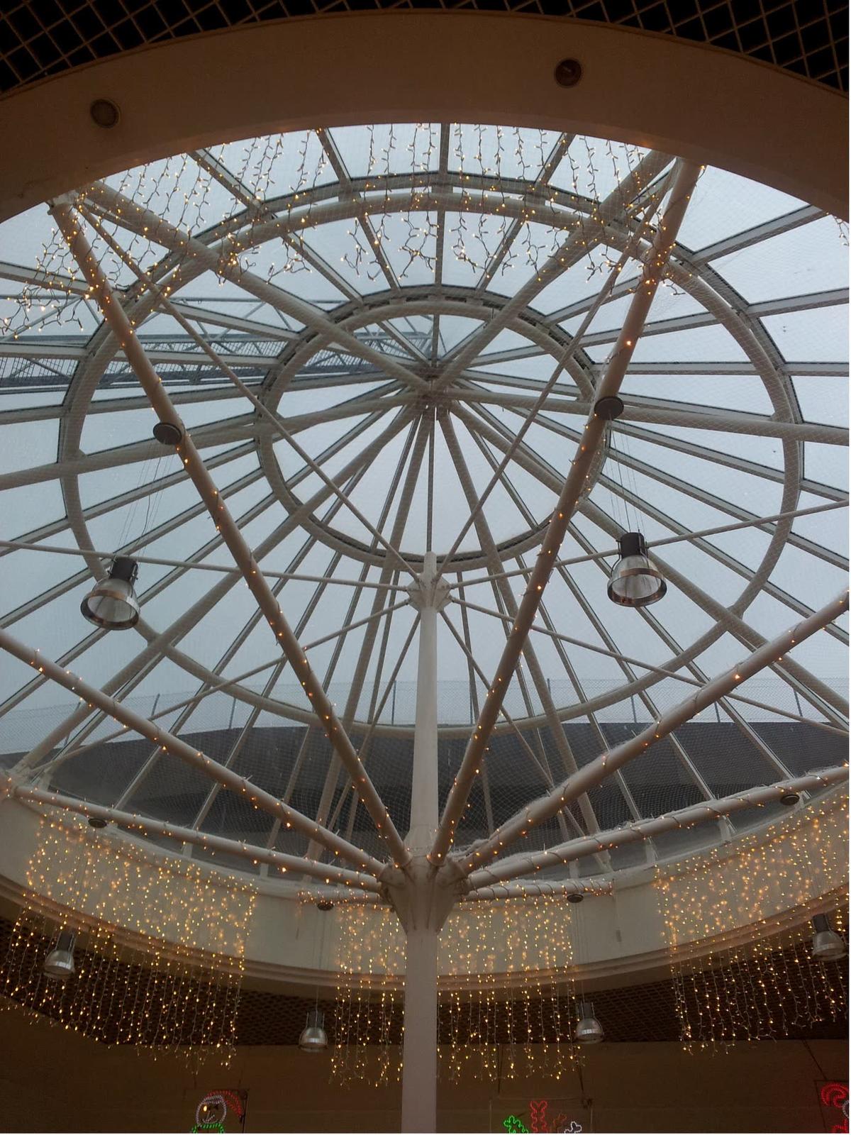 Single glazed Victorian heritage glass roof at Alexandra Palace: barrel-vault Georgian wired glass, red spider lift and site barriers — 194 glass panes replaced on one roof
